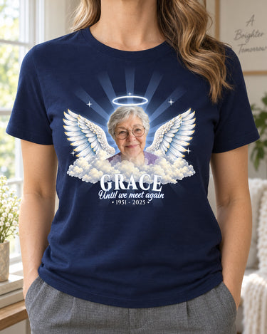 Woman wearing a navy in loving memory angel wings t-shirt with a grandmother's photo, a silver halo and the name Grace