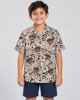 Island Tiki Vibes Hawaiian shirt with printed faces, worn by a child