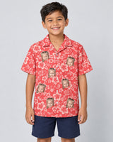 Japanese Hibiscus Blossom Hawaiian shirt with printed faces, worn by a child