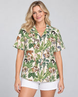 Jungle Jamboree Hawaiian shirt with printed faces, worn by a woman