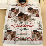 Personalized first Christmas couple photo blanket with pine sprigs and red ribbons spread across a made bed with white linen