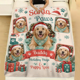 Personalized Santa Paws Christmas dog blanket with snowflakes, gifts and a stocking spread across a made bed with white linen