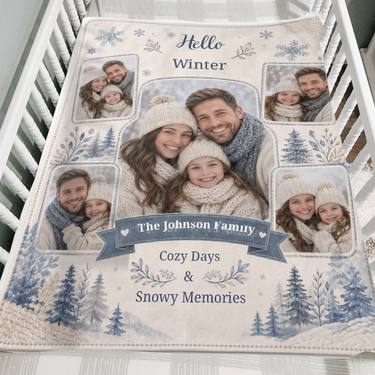 Five photo Hello Winter keepsake blanket in cream and dusty blue folded over the side of a wooden crib