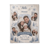 Flat lay of the Hello Winter family blanket showing the arched centre photo, four tilted photo frames and the curved family name on its navy ribbon