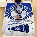Personalized cheer team blanket with the cheerleader photo, stars and silver script name spread across a made bed with white linen