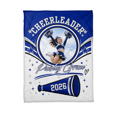 Flat lay of the personalized cheerleader blanket showing the circle photo frame, star swooshes and the megaphone with the custom year