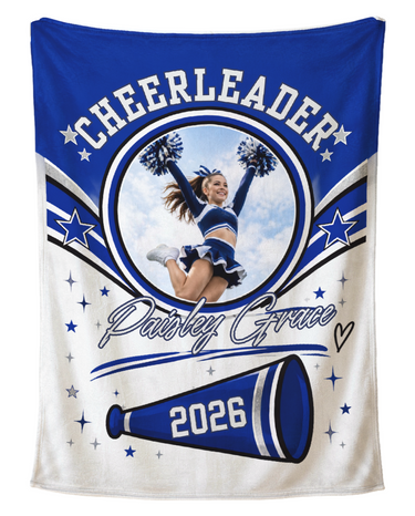 Personalized cheerleader photo blanket in royal blue and white with a round photo frame, CHEERLEADER arch lettering, the name in silver script and the year on a megaphone, shown flat on a pure white background