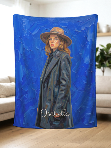 Hand held personalized oil painting blanket showing a painted woman in a wide-brim hat on cobalt blue brushstrokes with the name Isabella
