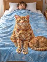 A boy asleep under a personalised cat portrait blanket, an oil painted orange tabby on sky blue brushstrokes with the name Milo, while the real cat naps on the rug beside the bed