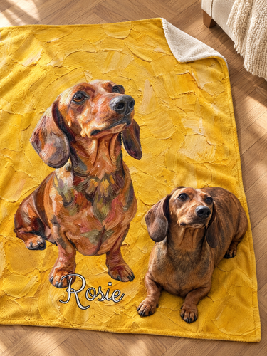 Custom dachshund portrait blanket laid on a herringbone wood floor, oil painted on sunflower yellow brushstrokes with the name Rosie, with the real dachshund lying on the corner