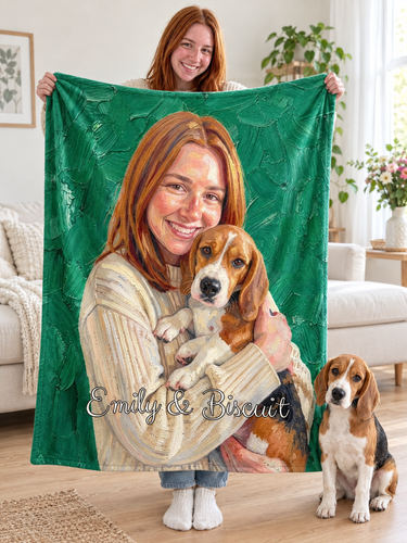 A young woman holding up her personalised oil painting blanket in a bright living room, the blanket printed with her portrait hugging her beagle on emerald green brushstrokes and the names Emily & Biscuit, with the real beagle puppy sitting beside her