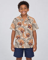 Lush Tropical Foliage Hawaiian shirt with printed faces, worn by a child
