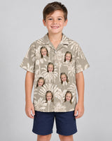 Monochrome Tropics in Cotton Grey Hawaiian shirt with printed faces, worn by a child