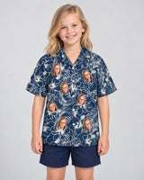 Navy Hibiscus Paradise Hawaiian shirt with printed faces, worn by a child