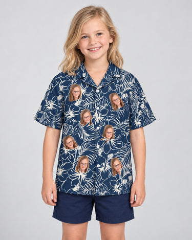 Navy Hibiscus Paradise Hawaiian shirt with printed faces, worn by a child