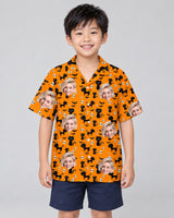 Orange Black Cat Halloween Hawaiian shirt with printed faces, worn by a child