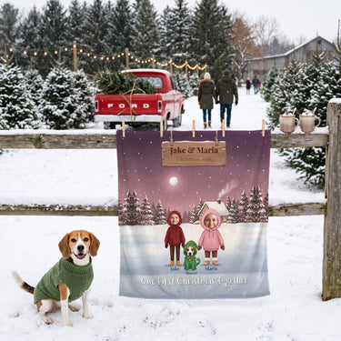 Our First Christmas Together couple blanket with faces and a beagle, hung on a fence at a Christmas tree farm