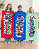 Three siblings holding custom name blankets in red, blue and mint reading Chloe, Noah and Sophia in paisley-filled bubble letters
