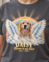 Close-up of the full-color print on a charcoal pet memorial t-shirt: a golden retriever with angel wings and a halo, a pastel rainbow, the name Daisy and the dates