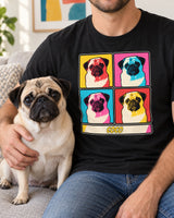 Adult seated beside a fawn pug in a bright room, wearing a black pop art pet portrait shirt with the same pug repeated in four colorful panels.