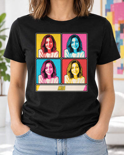 Black custom pop art portrait shirt worn in a bright studio, showing one photo repeated in four colorful halftone panels and a comic name strip.