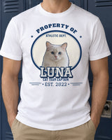White pet varsity shirt against a navy locker wall, showing a cat portrait, the name LUNA, navy and silver outlines and the year 2022.