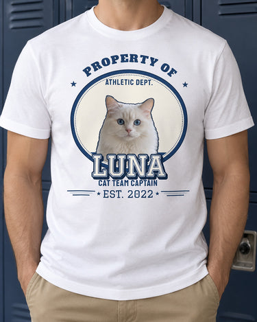 White pet varsity shirt against a navy locker wall, showing a cat portrait, the name LUNA, navy and silver outlines and the year 2022.
