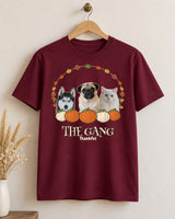 Maroon Thanksgiving pet photo shirt on a wooden hanger, showing three pets inside a leaf wreath above pumpkins, THE GANG lettering and Thankful below.
