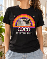 Woman wearing a black custom pet retro sunset t-shirt with a pug and a white cat rising from a striped sun and rainbow arcs and the name Coco in groovy script