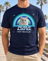 Man wearing a navy custom pet retro sunset t-shirt with a white cat in front of ocean-blue rainbow arcs and the name Luna