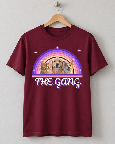 Maroon custom pet retro sunset t-shirt on a wooden hanger with three pets in front of purple and pink rainbow arcs and the name The Gang