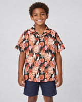 Rosy Paradise Hawaiian shirt with printed faces, worn by a child