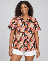 Rosy Paradise Hawaiian shirt with printed faces, worn by a woman