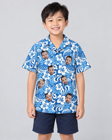 Royal Blue Tropics Hawaiian shirt with printed faces, worn by a child