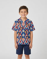 Shell Bell Ikat Christmas Hawaiian Shirt with printed faces, worn by a child