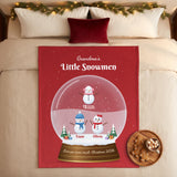 Snowman snow globe blanket with grandkids names on a cozy Christmas bed