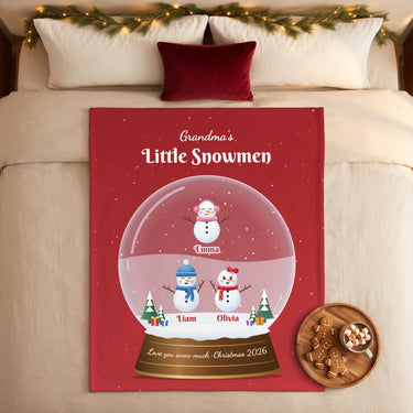 Snowman snow globe blanket with grandkids names on a cozy Christmas bed