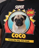 Close view of Coco's comic book portrait on a black tee, showing the cream inner ring, red cape folds, POW! star and yellow outlined name.