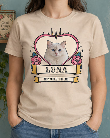 Natural pet tattoo photo tee worn with denim trousers, featuring a white cat inside a pink heart with pink roses, blue leaves and the name Luna.