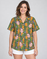 Tiki Surf Legend Hawaiian shirt with printed faces, worn by a woman