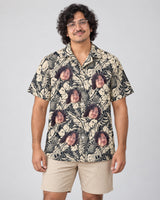 Tropical Garden Elegance Hawaiian shirt with printed faces, worn by a man