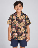 Tropical Grunge Bloom Hawaiian shirt with printed faces, worn by a child