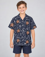 Tropical T-Rex Bloom Hawaiian shirt with printed faces, worn by a child