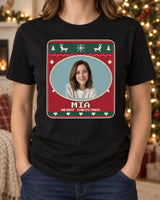 Black Christmas face photo tee in a living room, showing Mia inside a cream stitched oval on a red Nordic knit print with a Christmas greeting