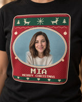 Close-up of cream pixel letters, tiny V stitches, Nordic reindeer and the oval portrait rim on a black Christmas face photo t-shirt