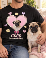 Adult wearer cropped below the chin on a cream sofa with a pink blanket and fawn pug, wearing the black candy heart shirt featuring the same pet and the name Coco.