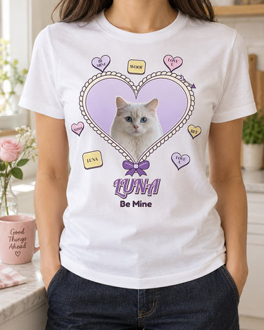 White pet Valentine shirt with Luna the cat inside a lavender heart, cream scalloped edging, conversation candies and Be Mine lettering in a bright kitchen.