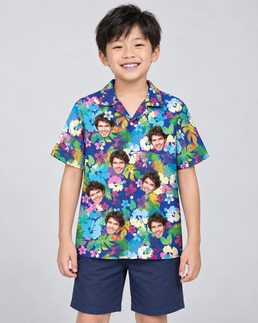 Vibrant Hibiscus Hawaiian shirt with printed faces, worn by a child