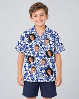 Weathered Tropic Hibiscus Hawaiian shirt with printed faces, worn by a child