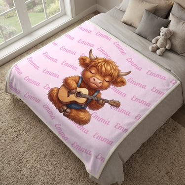 Highland cow name blanket in cotton pink spread over a bed